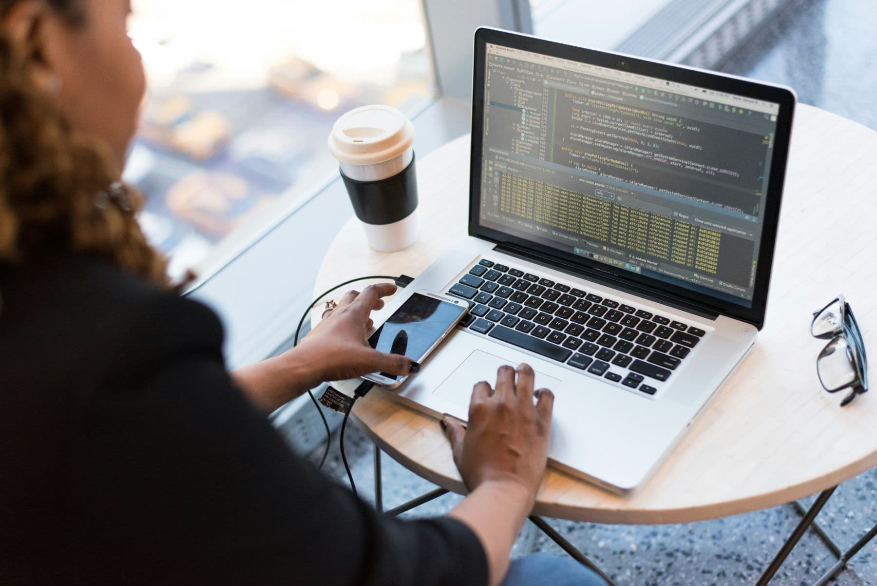 Developer building a mobile app on a laptop