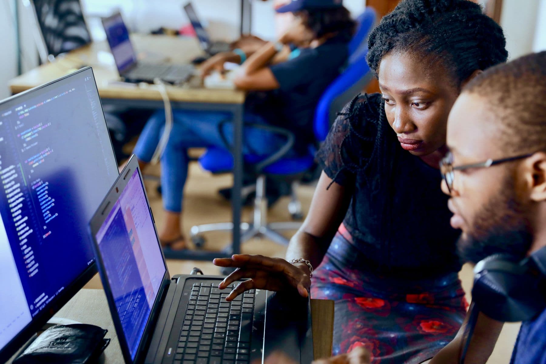 Two engineers reviewing software together on a laptop